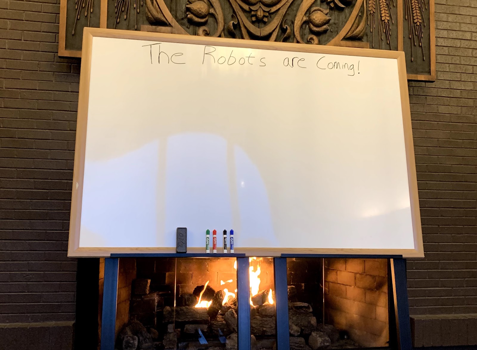 A white board in front of a fireplace during a HR professionals retreat