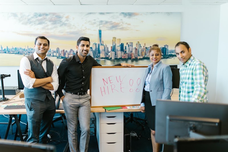 A group of new hires posing for a company photo