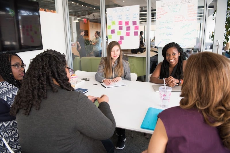 A diverse female team discussing business