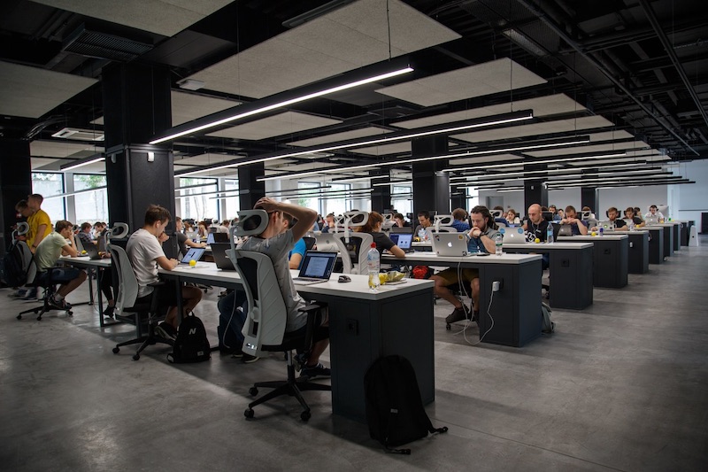 A large office with employees at their computers 