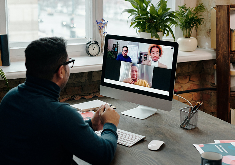 A remote team having a virtual meeting with their manager.