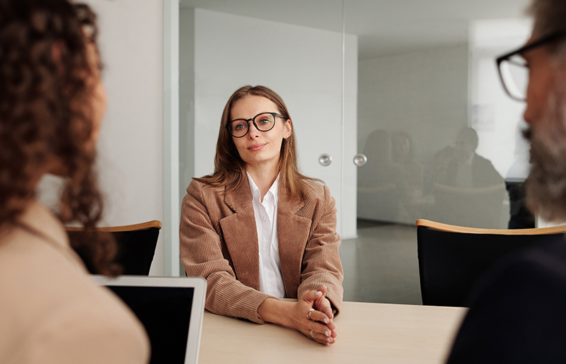 An attractive woman interviews for a role, which can lead to beauty bias among the recruiters.