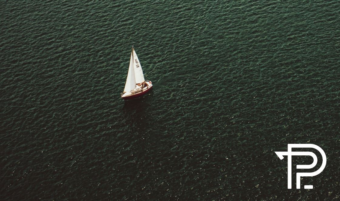 A sailboat on open waters with PiperKey logo.