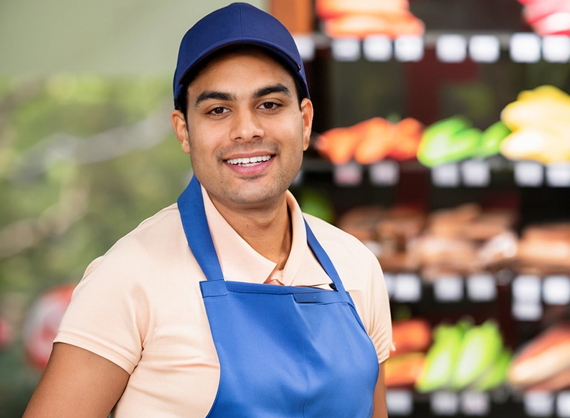A retail worker wearing a uniform specified by the company's policy.