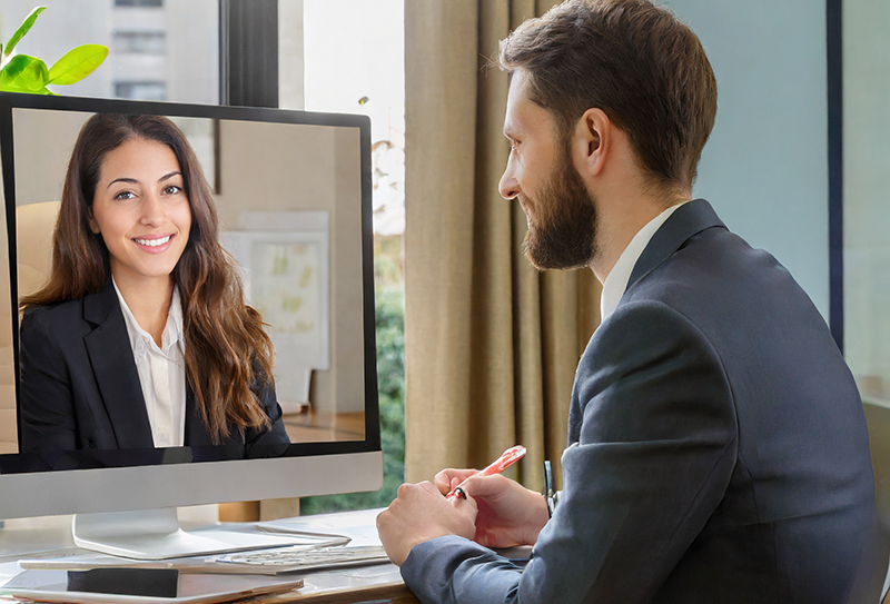 A remote manager having a virtual performance management meeting with a remote employee.