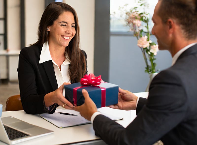 An employee receiving a gift as a reward for excellent performance.